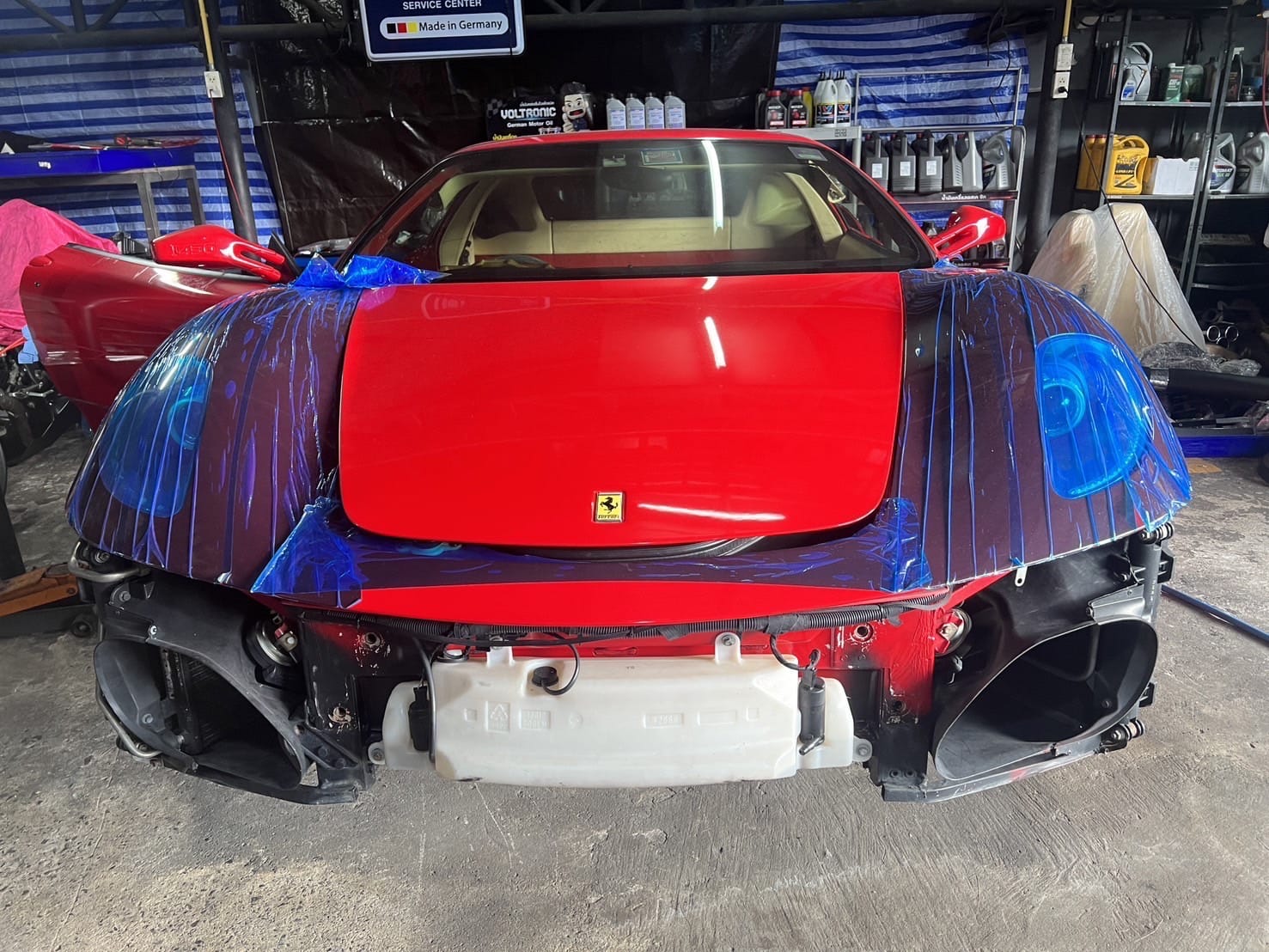 Red Ferrari with a broken windscreen.